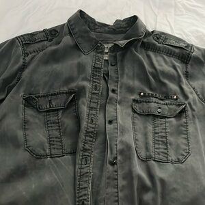 Grey button down shirt.